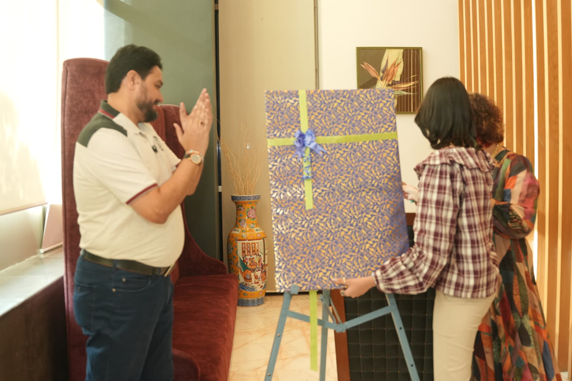 Unveiling the book poster with her parents.