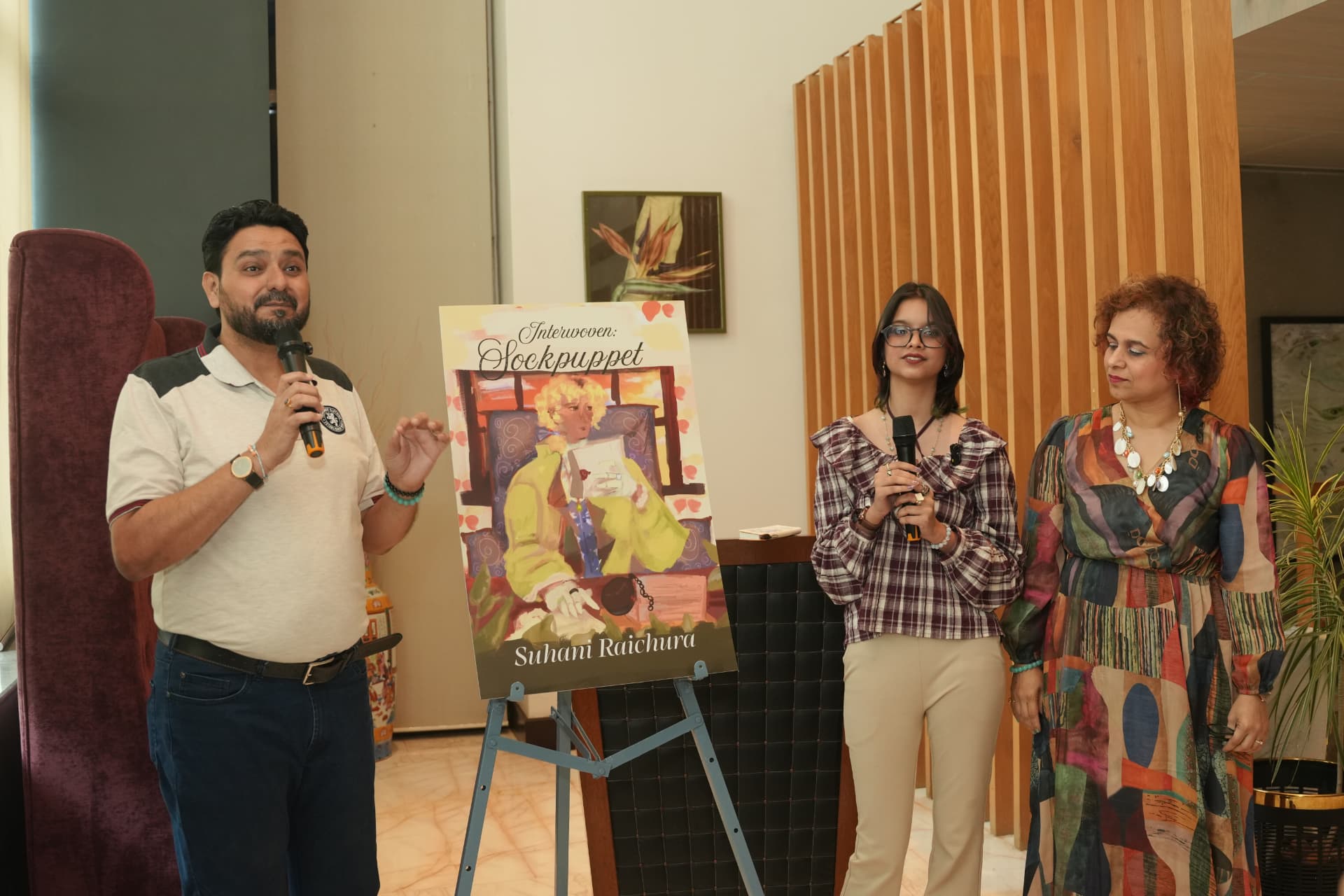 Suhani Raichura with her parents, Kalpesh Raichura (Father) and Shalaka Raichura (Mother), with the freshly unveiled cover.