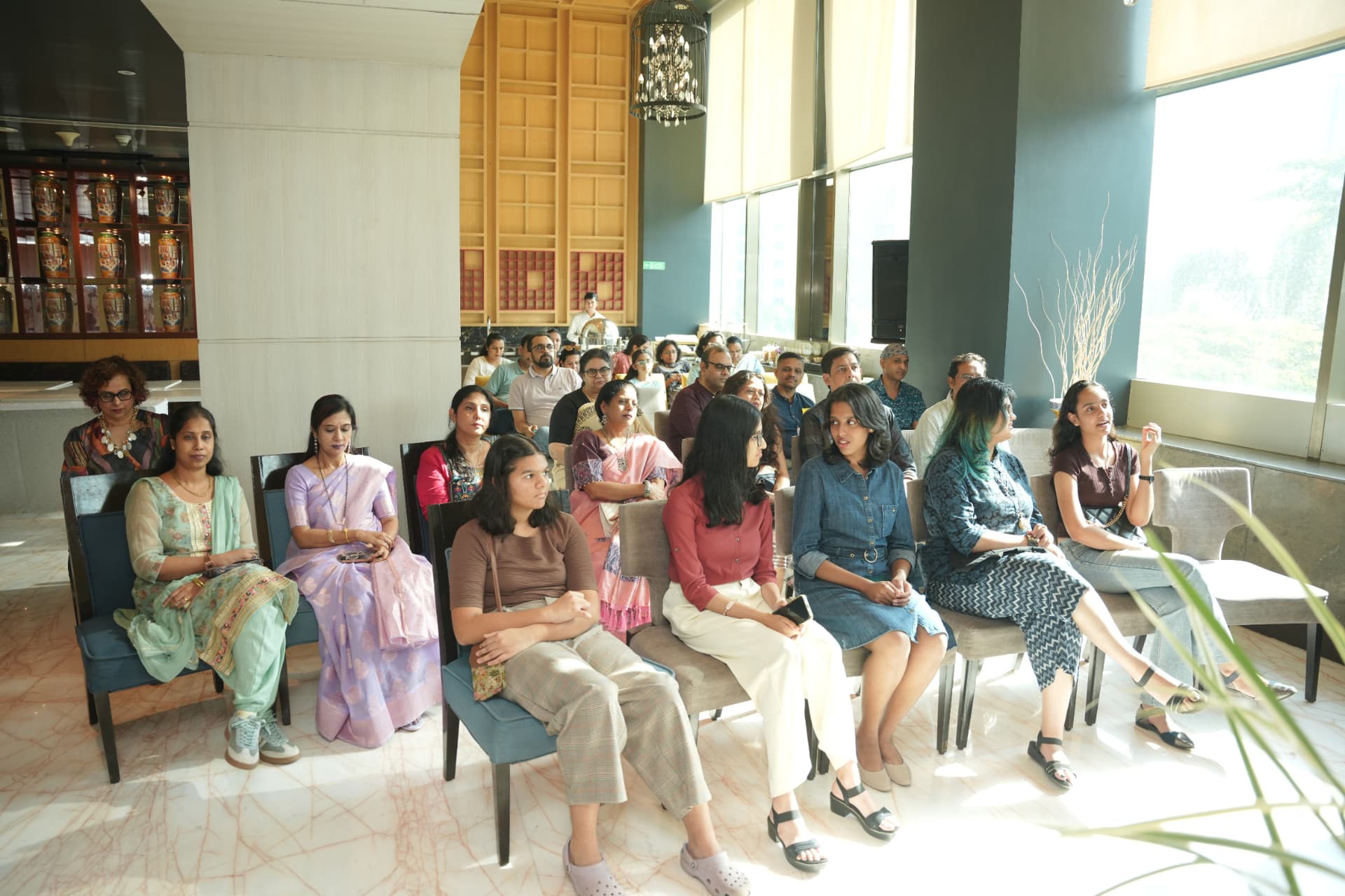 The room fills with an attentive audience.